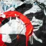a close up of a wall with graffiti on it